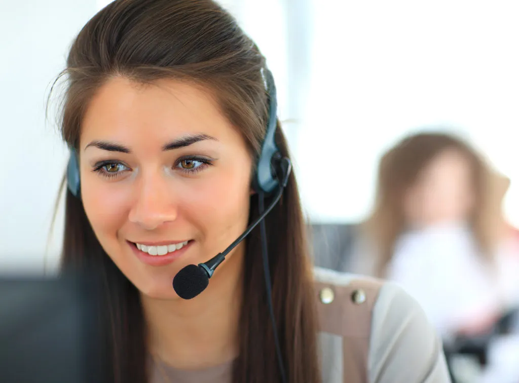 A phone operator answers calls for Travel Outlook, #1 in hotel call center companies.